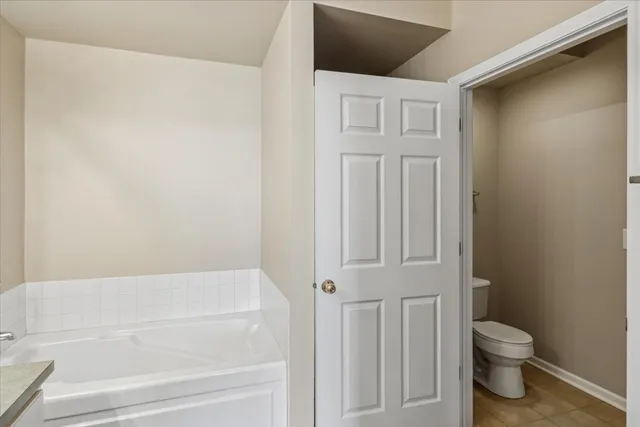 a bathroom with a toilet and a bathtub