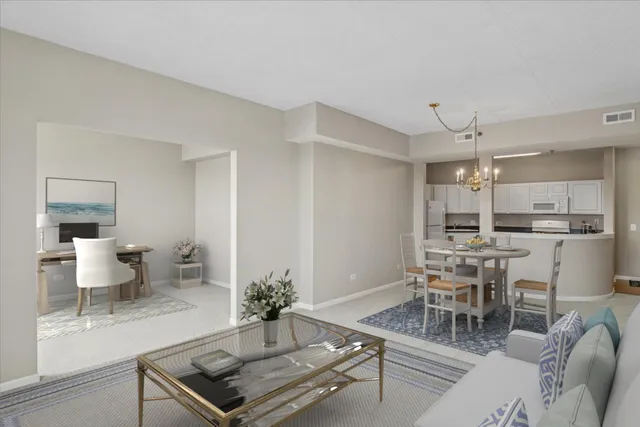 a living room with furniture and view of kitchen