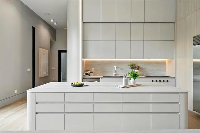 a kitchen with kitchen island a sink stove and refrigerator