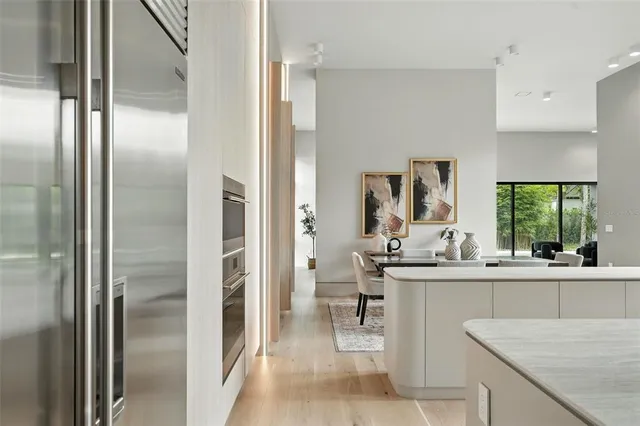 a view of a hallway with wooden floor and staircase
