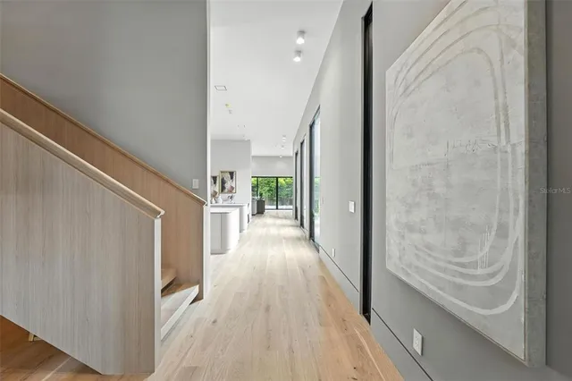 a bedroom with a bed painting on wall and a potted plant