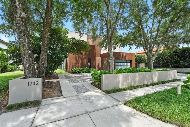 a front view of a house with a garden