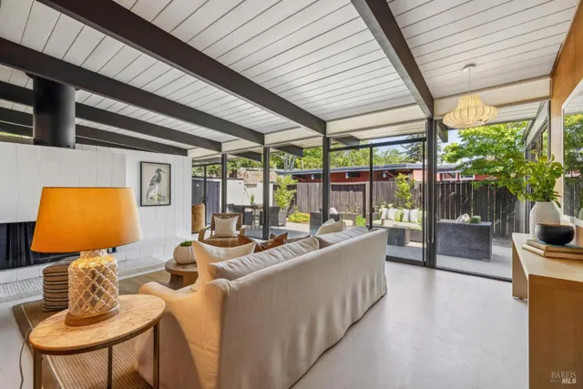 a living room with furniture fireplace and flat screen tv