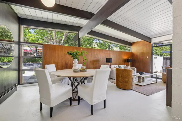 a view of an outdoor dining space with a table and chairs