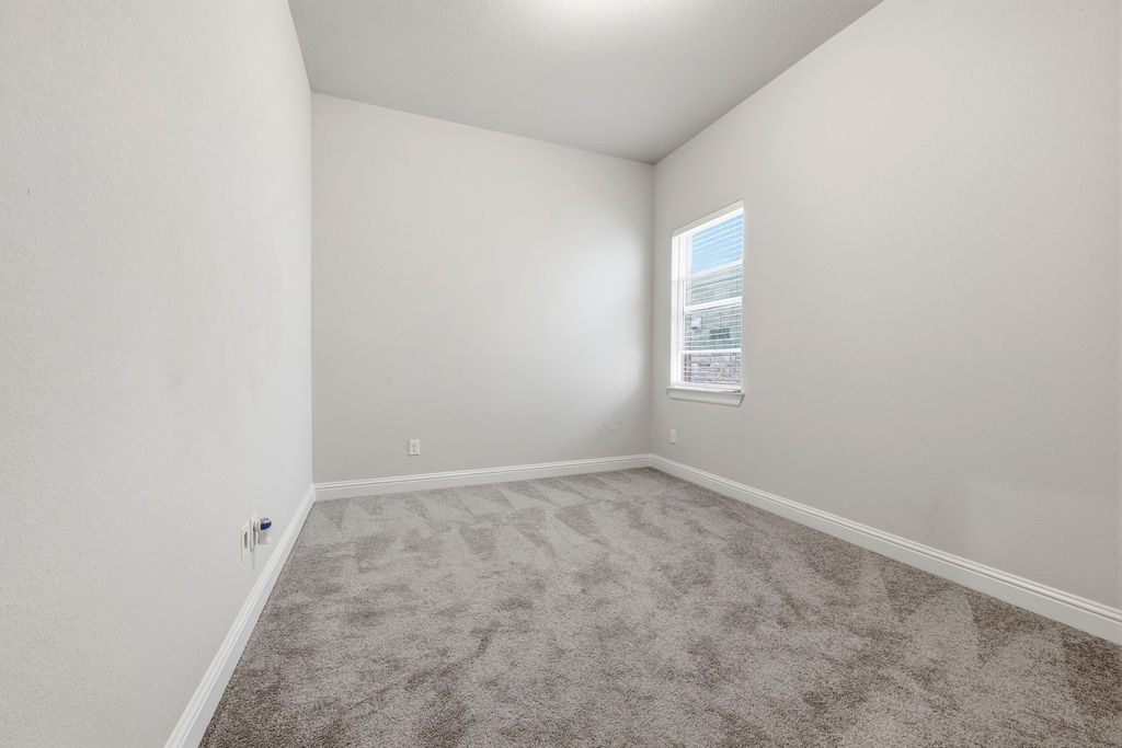 2032 Base Burner Path Leander, TX 78641 - Photo 21 of 34 Room featuring light gray carpet, white baseboards, and neutral wall paint