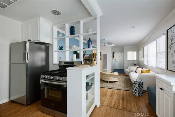 a kitchen with stainless steel appliances a refrigerator sink and stove