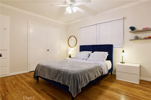 a bedroom with a bed and a ceiling fan