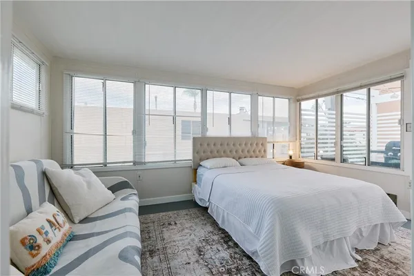 a bedroom with a large bed and a couch