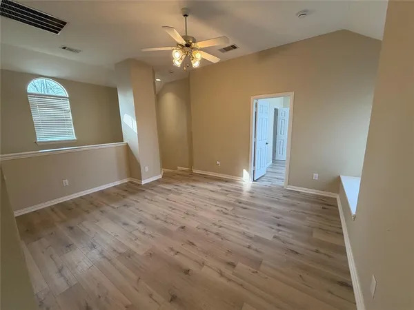 wooden floor in an empty room with a window