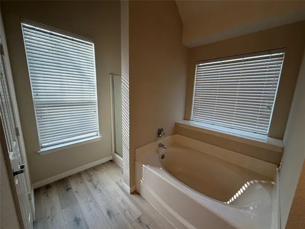 a bathroom with a bathtub and a window