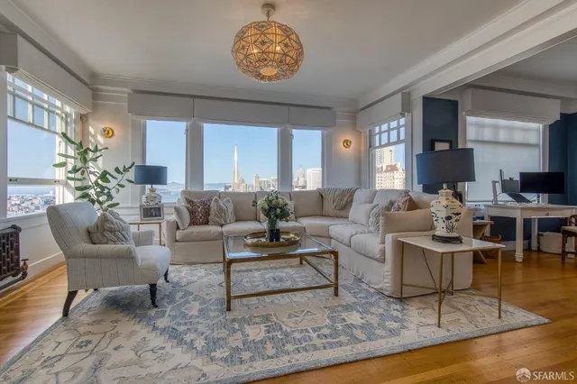 a living room with furniture a dining table and a fireplace