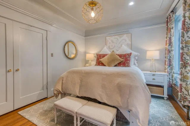 a bed room with a bed mirror and a table