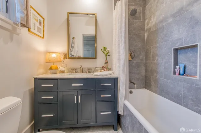 a bathroom with a sink a vanity and a bathtub