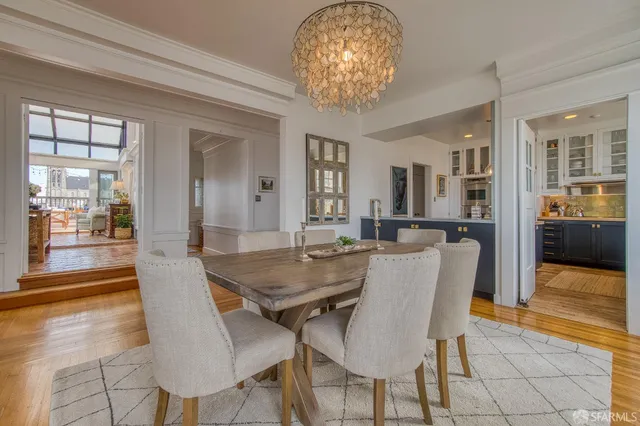 a view of a dining room with furniture and chandelier