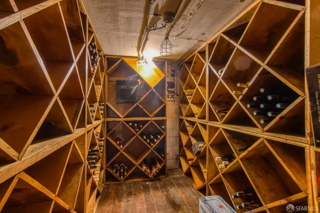 a blue bed with white walls and a shower