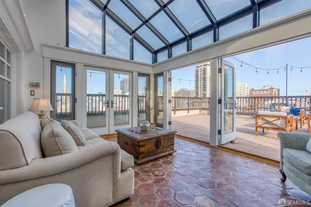 a living room with furniture a rug and a large window