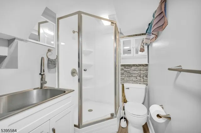 a bathroom with a granite countertop toilet sink and shower