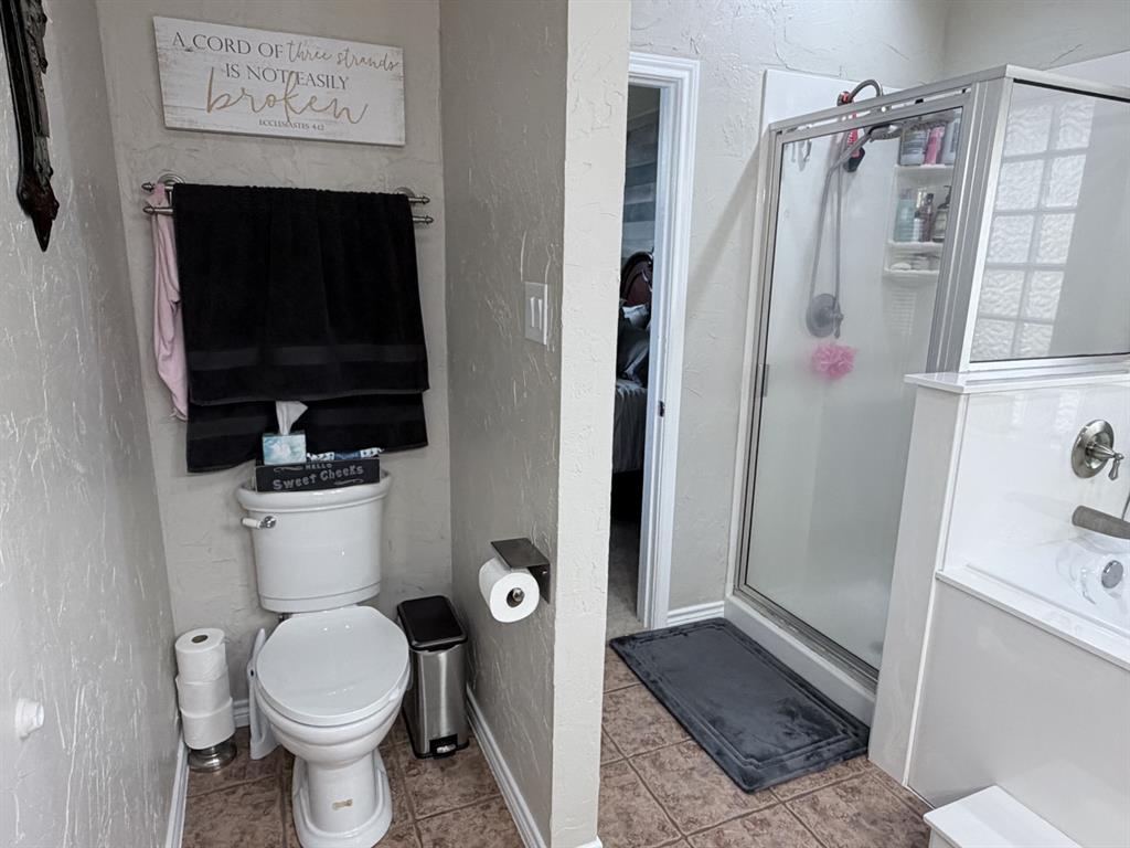 313 An County Road, Unit 2145 Palestine, TX 75801 - Photo 26 of 40 Walk-in shower with clear glass enclosure and tile flooring