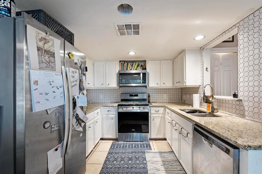 806 Winflo Drive, Unit 4 Austin, TX 78703 - Photo 1 of 1 a kitchen with stainless steel appliances granite countertop a stove sink and refrigerator