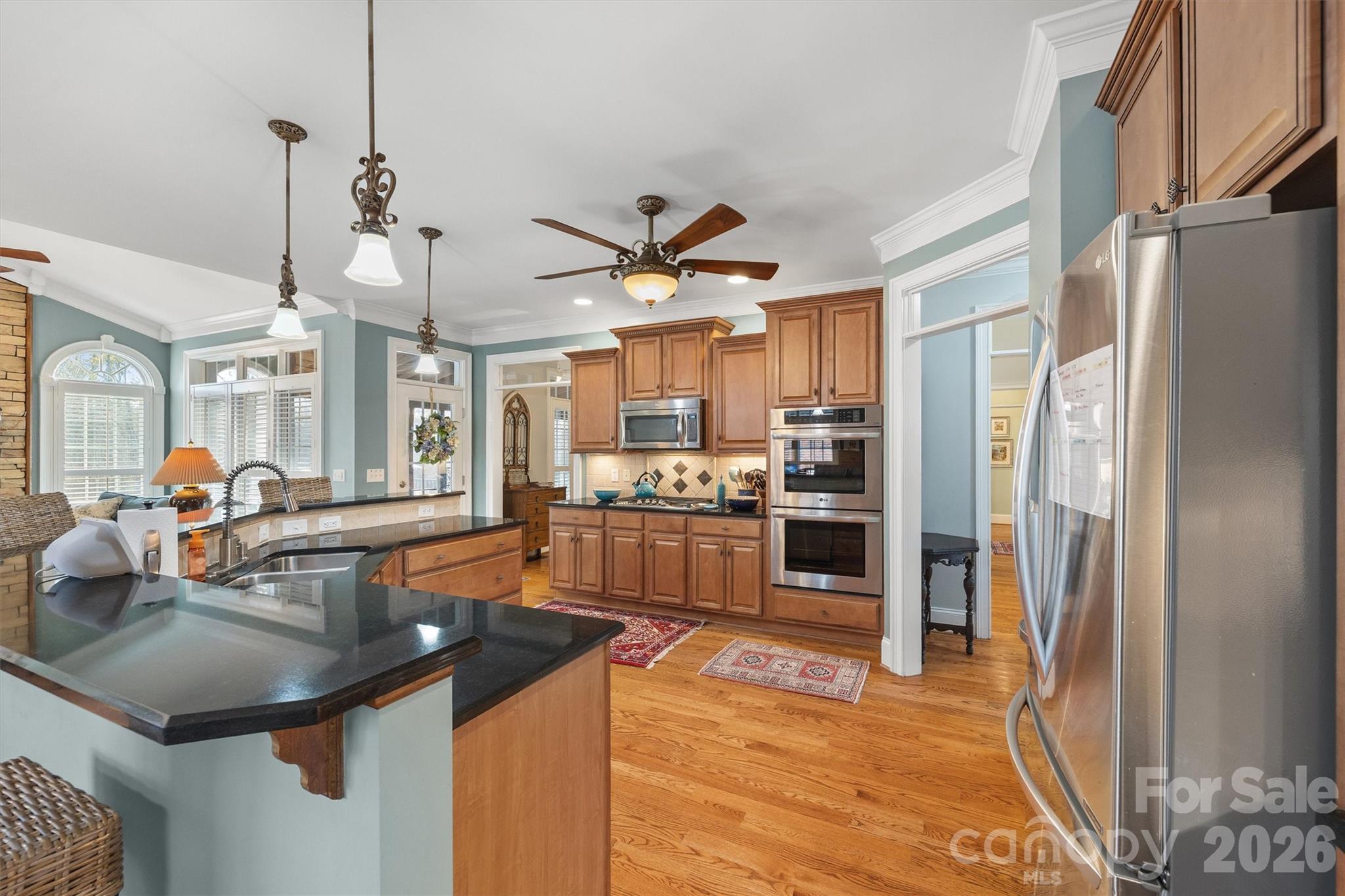1177 Springlake Road York, SC 29745 - Photo 11 of 48 a kitchen with stainless steel appliances granite countertop a sink a stove and a refrigerator