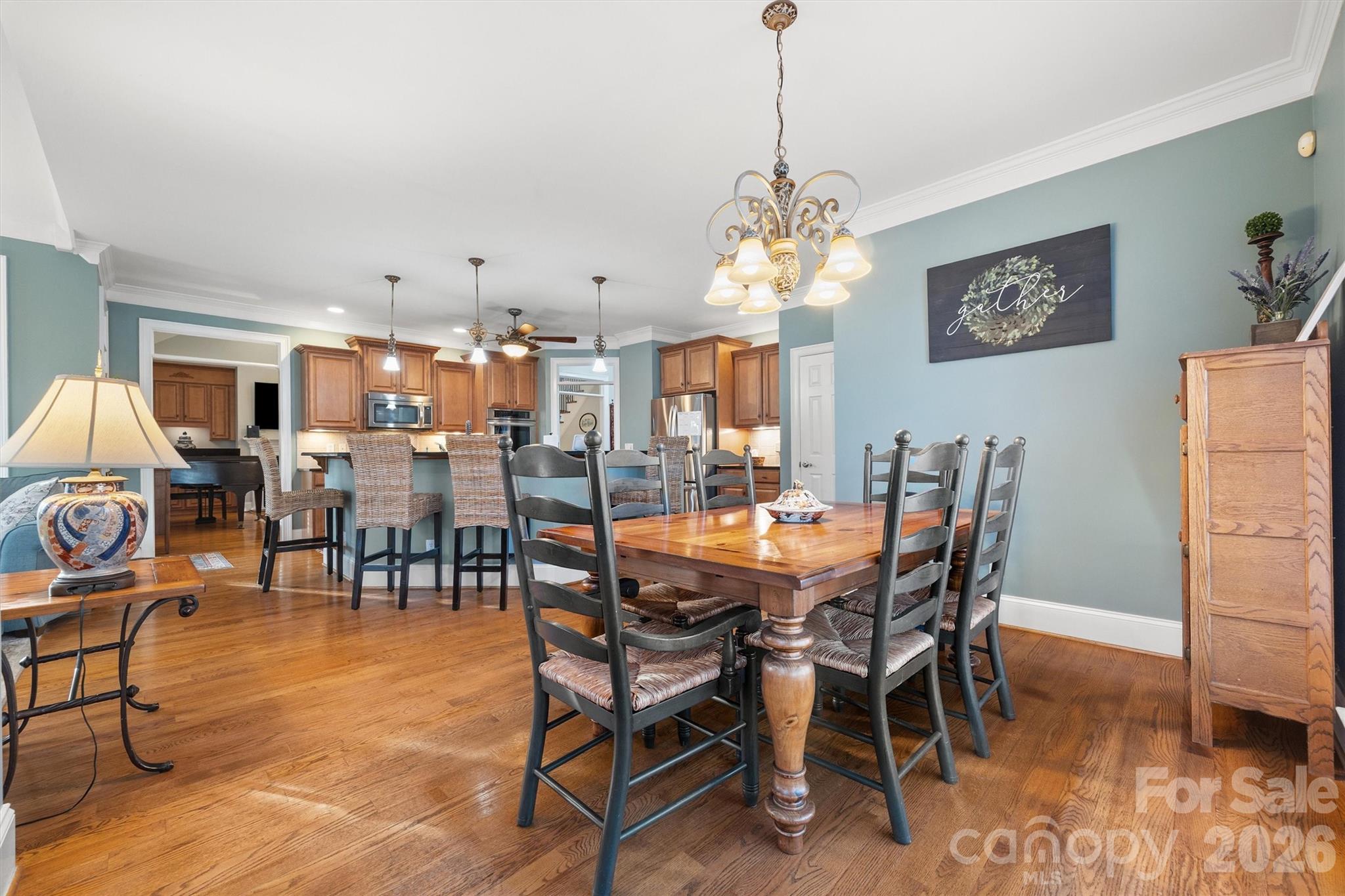 1177 Springlake Road York, SC 29745 - Photo 18 of 48 a view of a dining room and livingroom with furniture wooden floor a rug a painting and a chandelier
