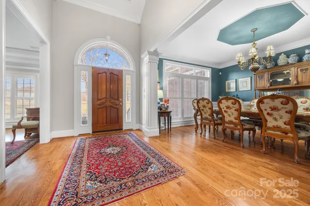 a living room with furniture a table and wooden floor