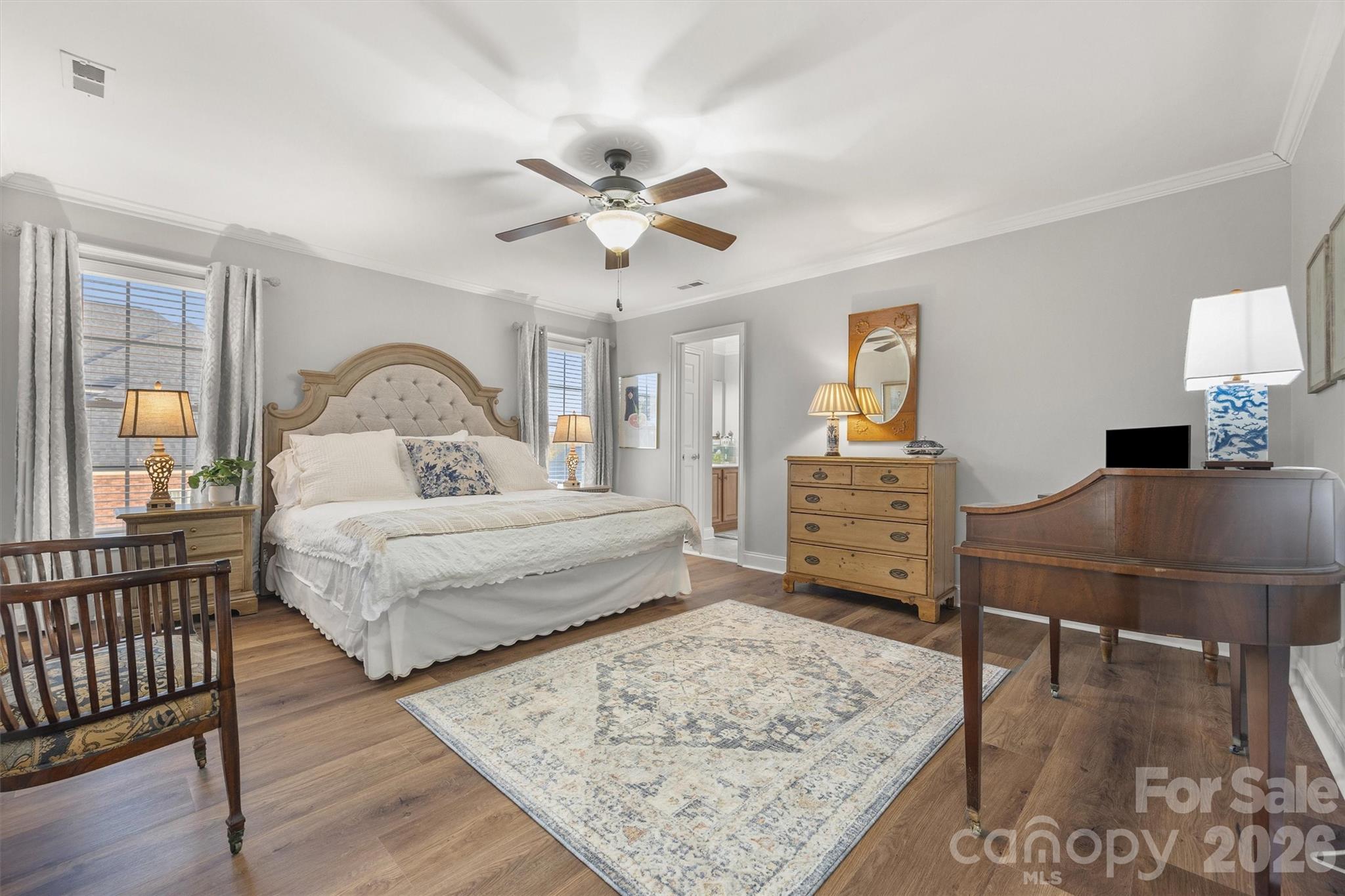 1177 Springlake Road York, SC 29745 - Photo 32 of 48 a bedroom with a bed a dresser and wooden floor