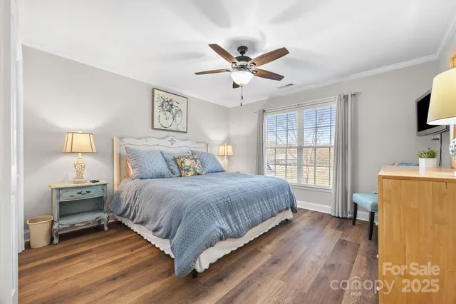 a spacious bedroom with a bed and a flat screen tv