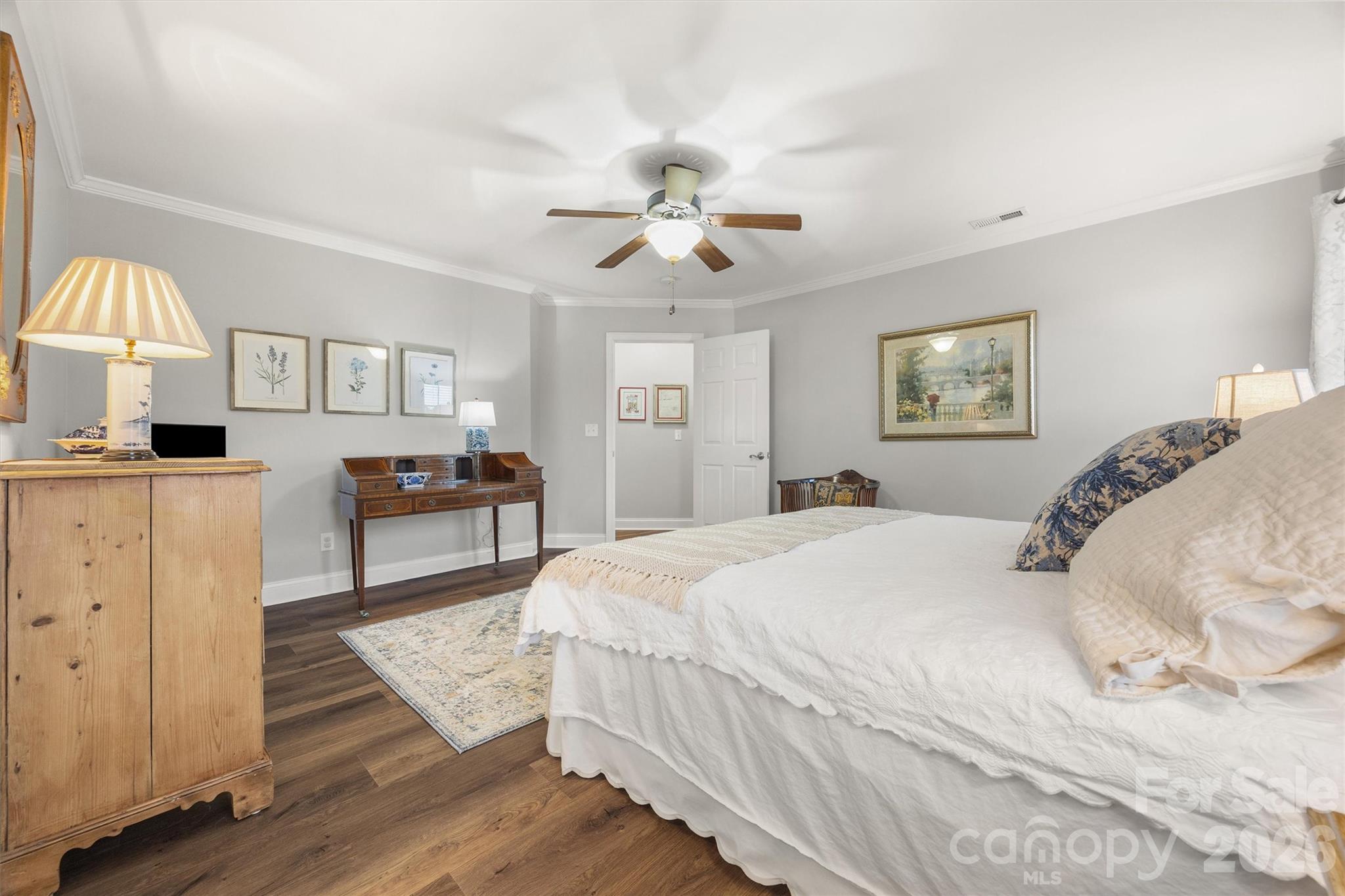 1177 Springlake Road York, SC 29745 - Photo 33 of 48 a spacious bedroom with a bed and a chandelier