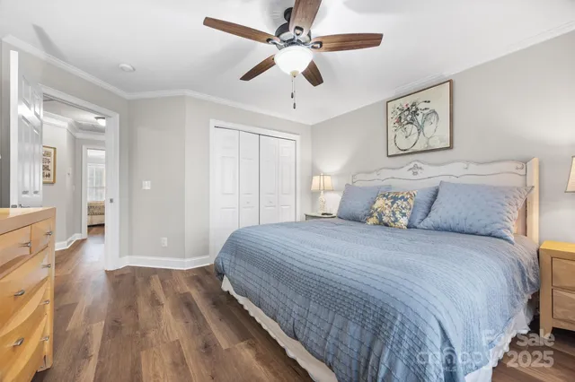 a spacious bedroom with a bed and a chandelier
