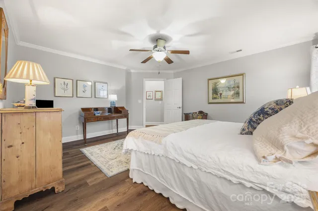 a spacious bedroom with a bed and a chandelier
