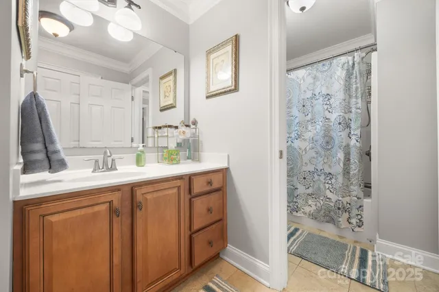 a bathroom with a sink mirror and a shower