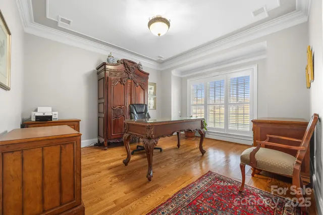 a living room with furniture a piano and a window