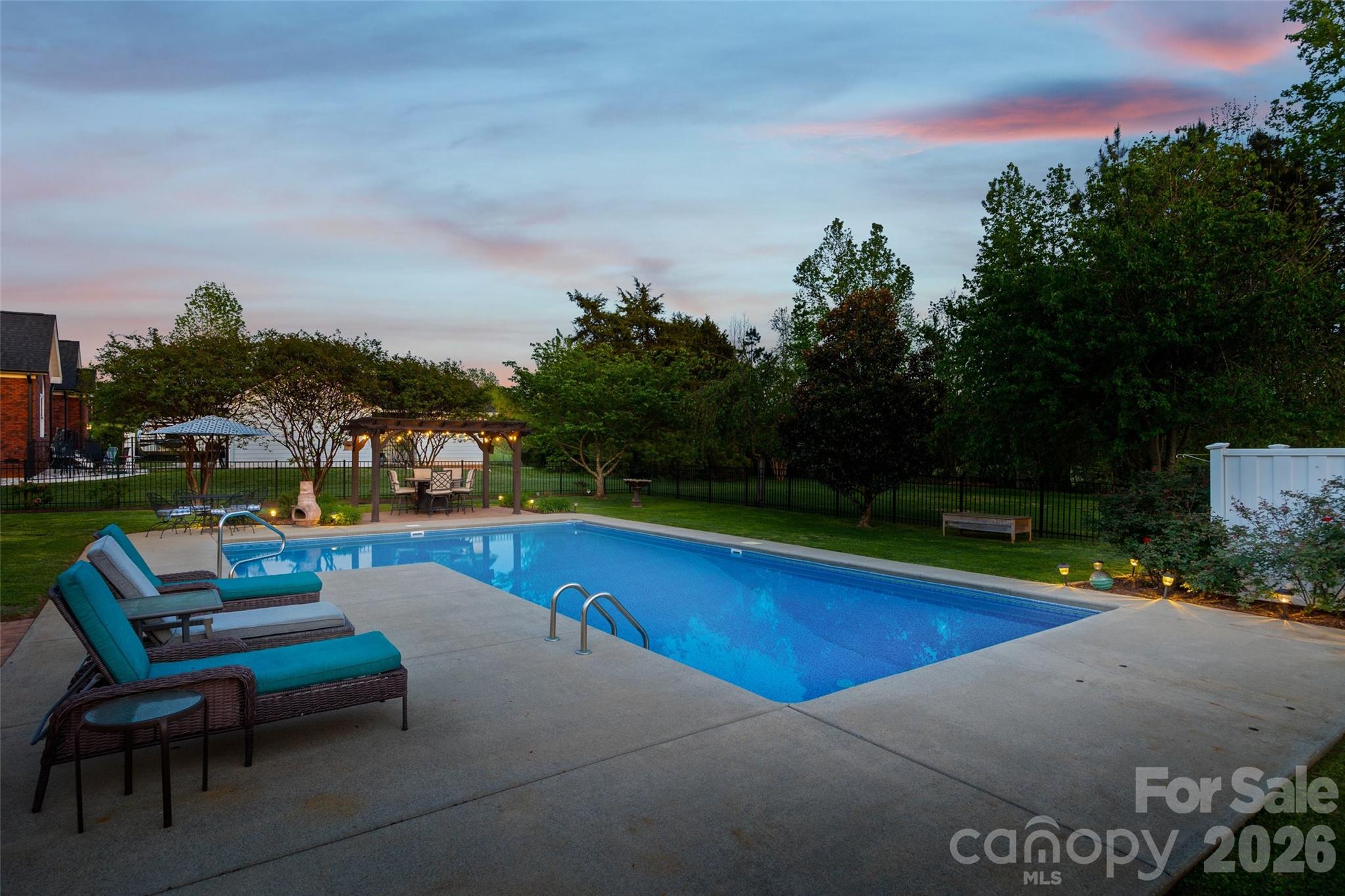 1177 Springlake Road York, SC 29745 - Photo 46 of 48 a view of swimming pool with outdoor seating and trees in the background