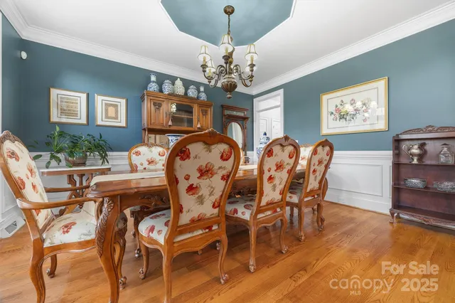 a view of a dining room with furniture and chandelier