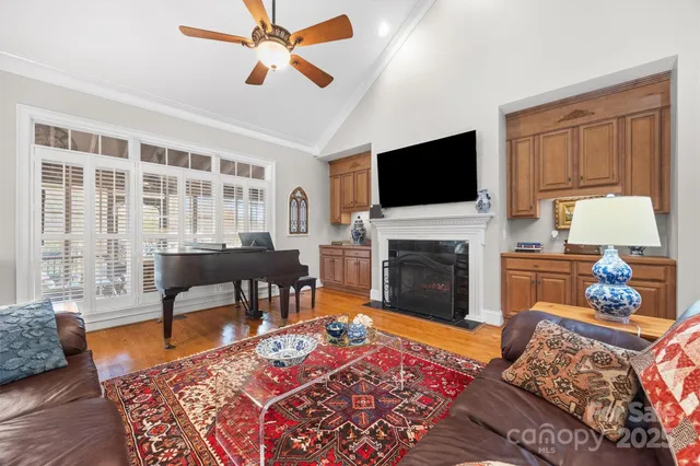 a living room with furniture a fireplace and a flat screen tv