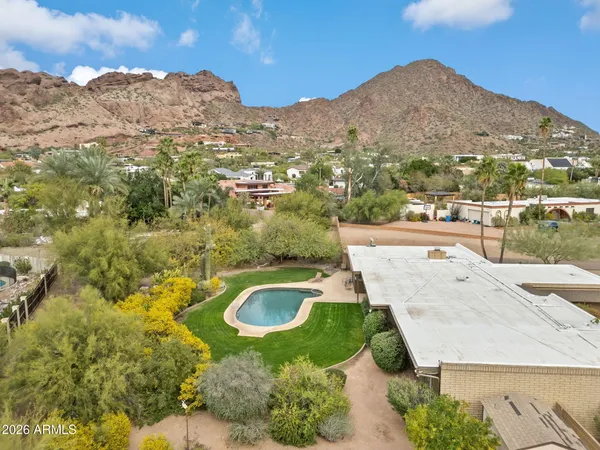 a view of a sink and mountains in the background