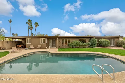 a view of a swimming pool with a patio