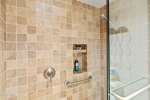 a view of walk in closet with clothes