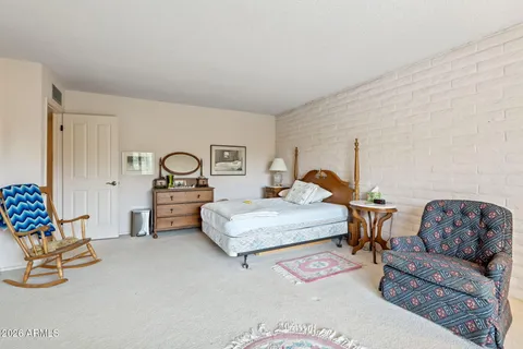 a living room with furniture a flat screen tv and a window
