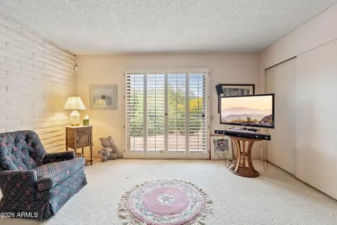 a spacious bedroom with a bed and large windows