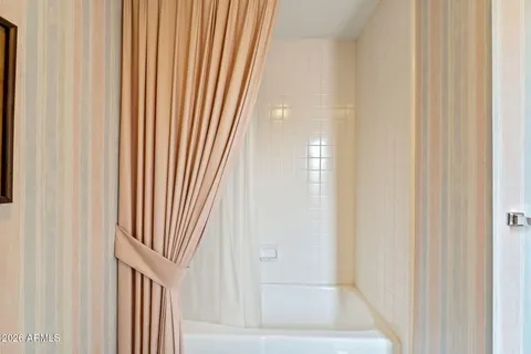 a bathroom with a sink mirror and a shower