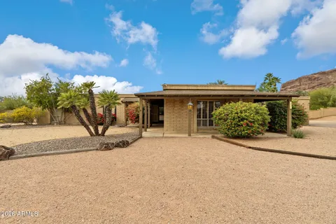 a view of a house with a backyard