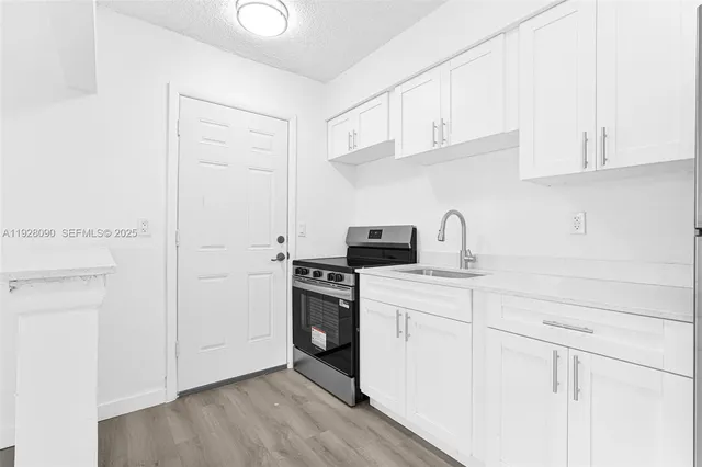 a kitchen with a sink cabinets and appliances