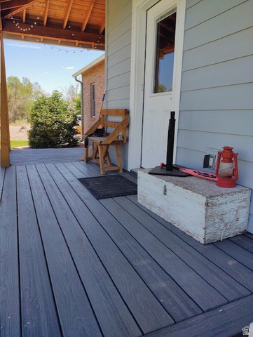 2170 Highway 357 Beaver, UT 84713 - Photo 15 of 56 Covered porch with wood-finish decking, horizontal siding, and a wood-paneled ceiling