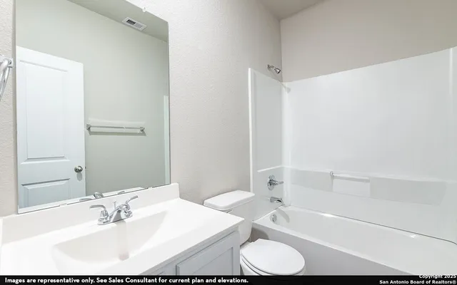 a bathroom with a bathtub shower sink and a toilet