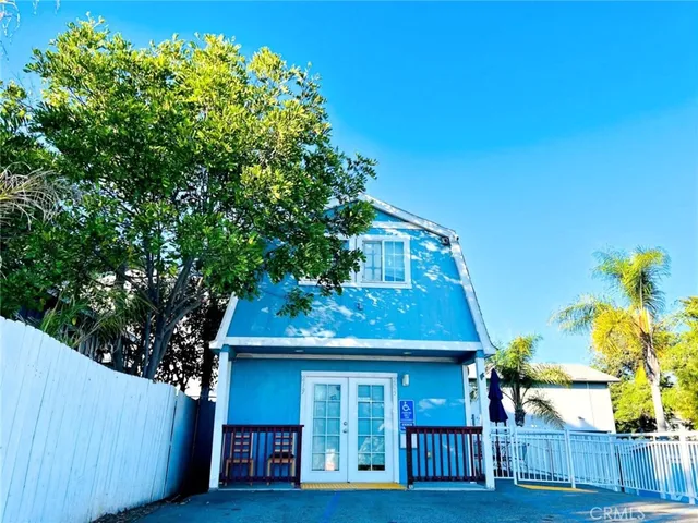 a view of a porch with wooden floor and outdoor seating