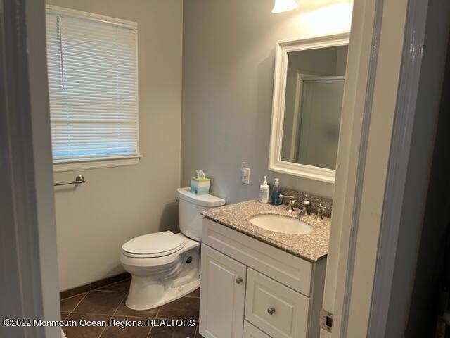 22 Robin Road Rumson, NJ 07760 - Photo 11 of 12 a bathroom with a granite countertop toilet a sink and a mirror
