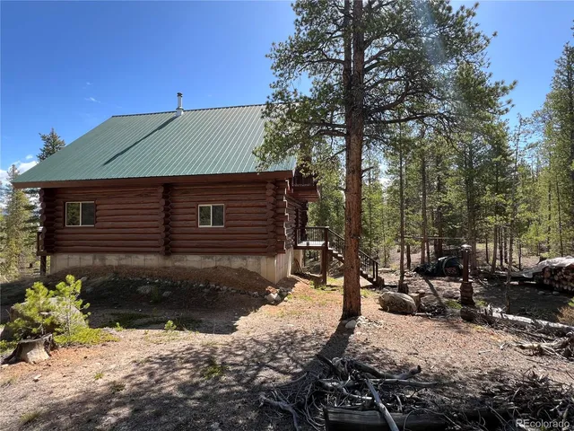a backyard of a house with a yard and outdoor seating
