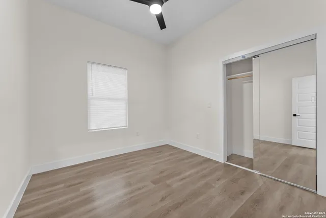 a view of a room with wooden floor